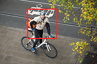 Video frame showing person with bicycle